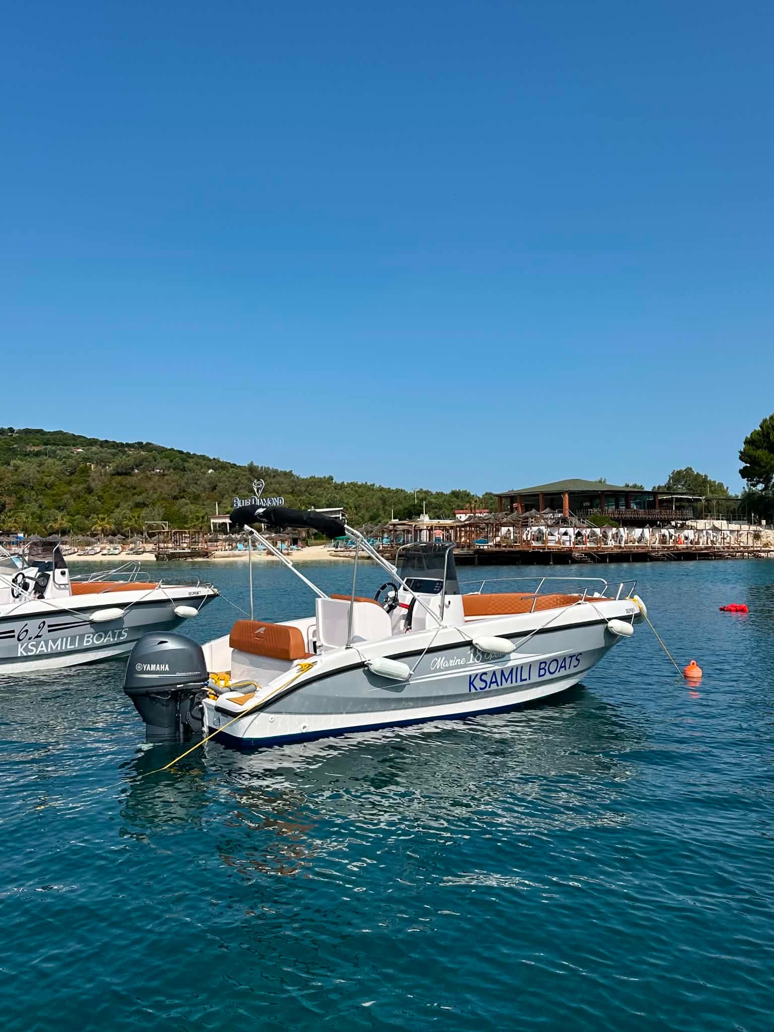 Two Ksamili Boats anchored on bright turquoise water off the Ksamil beach club